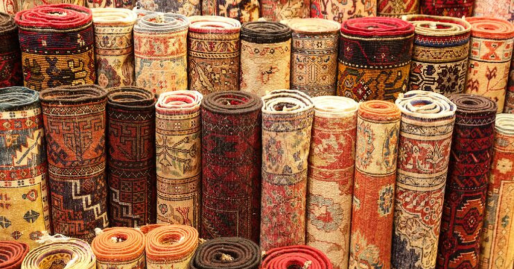 Kashmiri carpets stacked together representing Kashmiri culture